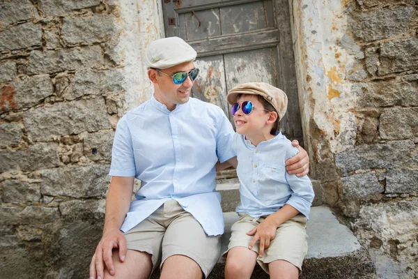 Happy father and son having rest outdoors in city — Stock Photo, Image