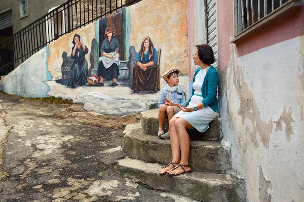 Young mother and son walking outdoors in city — Stock Photo, Image