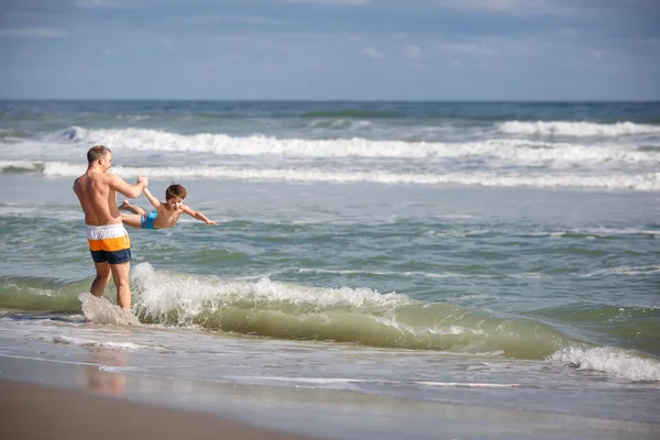 Father and son having fun on a tropical beach Royalty Free Stock Images