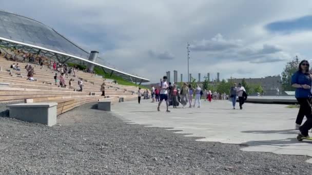 Moscou, Rússia - 06.13.2021: Anfiteatro de verão no Parque Zaryadye. "The Glass Bark", que cobre o anfiteatro e o jardim do telhado da Filarmônica. As pessoas caminham no parque central de Moscou. — Vídeo de Stock