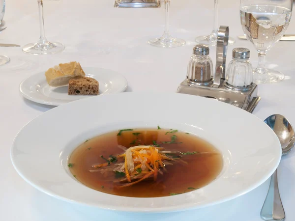 Beef consomme with root vegetables and meat — Stock Photo, Image