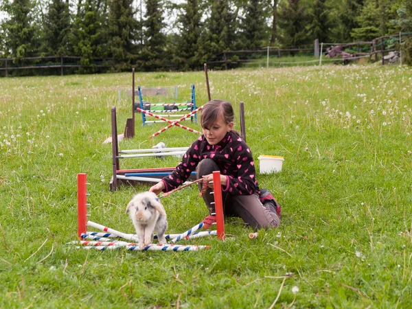 Girl practise jumping with bunny — Stock Photo, Image