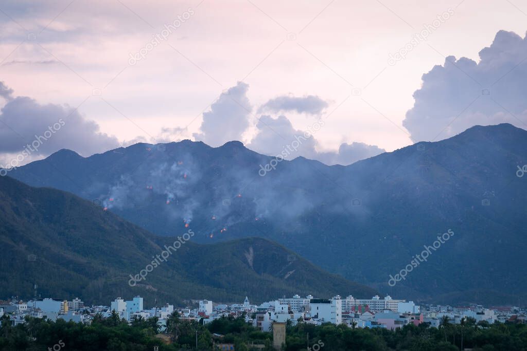 An evening view of the fire across the forest hills just outside the town. Nha Trang, Vietnam