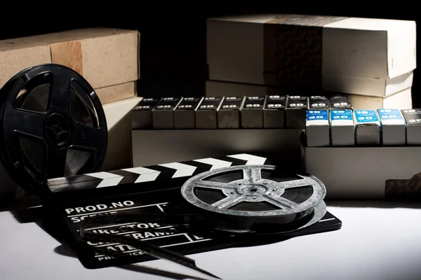 Reel with film and cinema clap — Stock Photo, Image