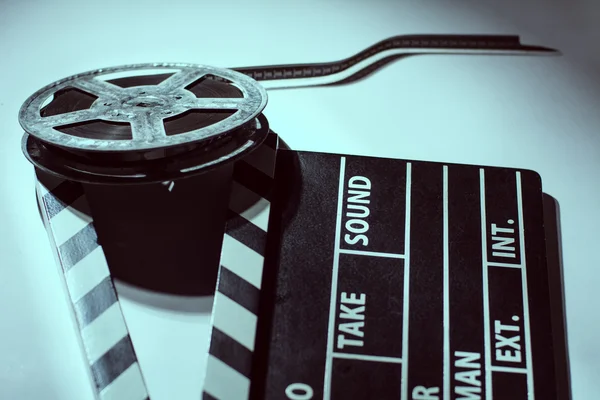 Old rusty roll of film and cinema clap — Stock Photo, Image