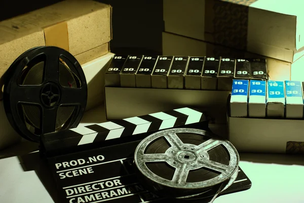 Reel with film and cinema clap — Stock Photo, Image