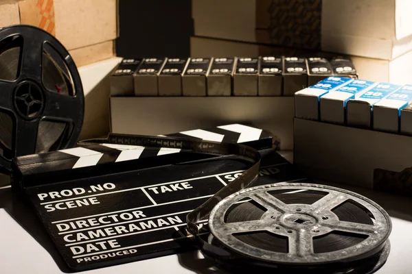 Reel with film and cinema clap — Stock Photo, Image