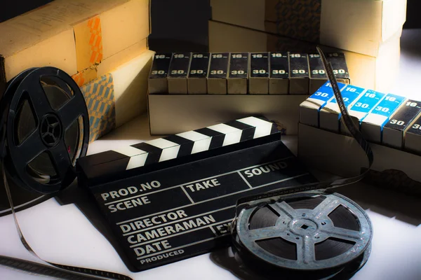 Reel with film and cinema clap — Stock Photo, Image