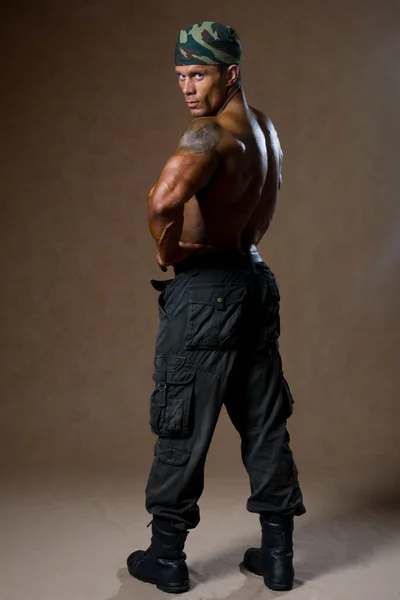 Muscular warrior wearing a cap — Stock Photo, Image