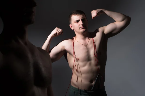 Adult male fitness demonstrates biceps — Stock Photo, Image