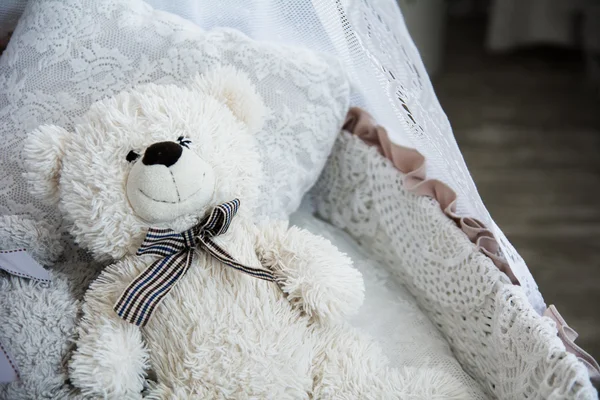 Children's cot with a teddy bear — Stock Photo, Image