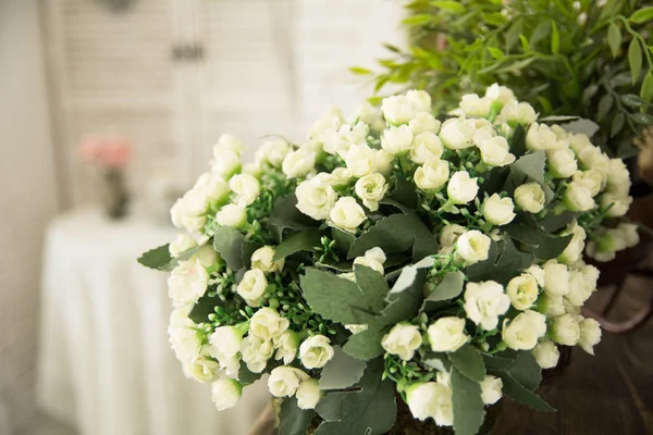 Vase with white small flowers in the interio — Stock Photo, Image