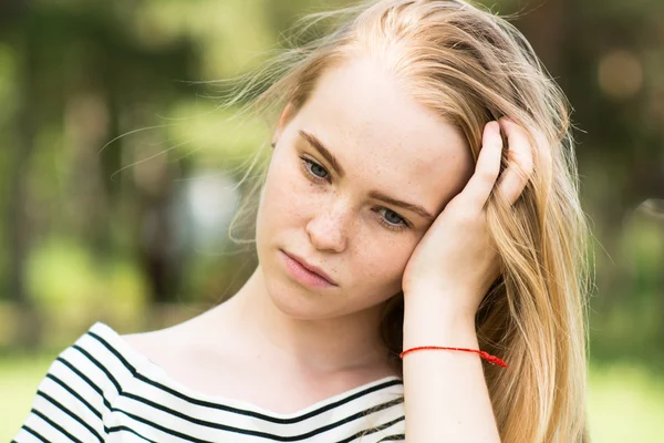Close-up of thoughtful girl in a striped dress — Stock Photo, Image