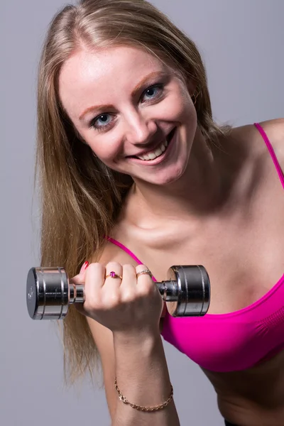 Portrait of smiling beautiful girl with dumbbells — Stock Photo, Image