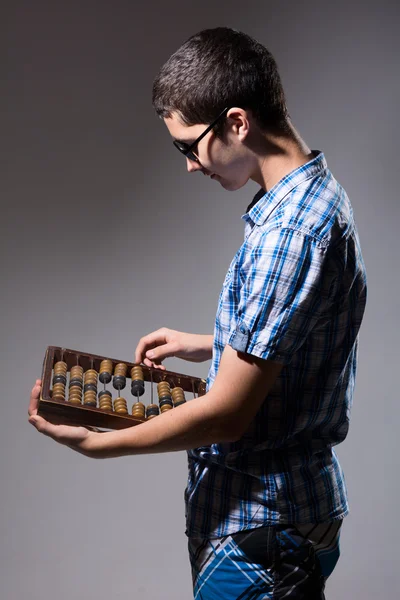 Enterprising young man with an abacus. — Stock Photo, Image