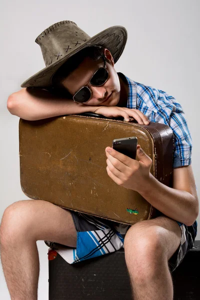 Man with a suitcase is waiting phone call. — Stock Photo, Image