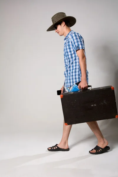 Portrait of a young man in a full-length coming from the suitcas — Stock Photo, Image