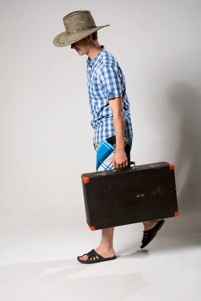 Portrait of a young man in a full-length coming from the suitcas — Stock Photo, Image