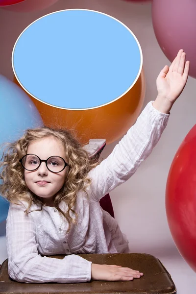 Girl in glasses with hand raised wants to ask — Stock Photo, Image
