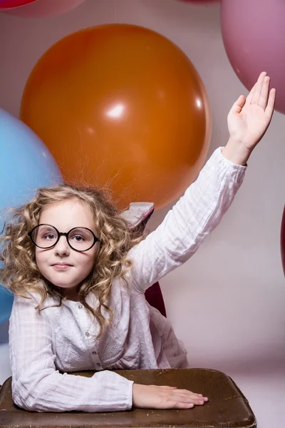 Girl in glasses with hand raised wants to ask. — Stock Photo, Image