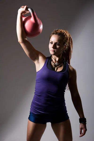 Portrait of young attractive female doing kettle bell exercise o — Stock Photo, Image