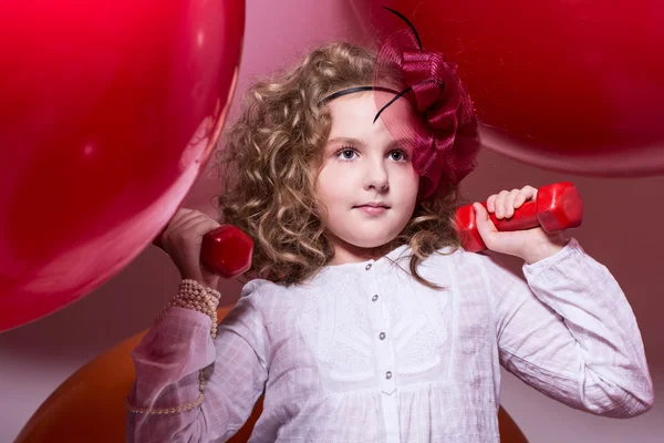 Girl schoolgirl involved with dumbbells — Stock Photo, Image