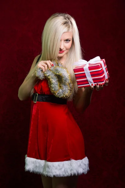 Portrait of a girl with Santa striped gift. — Stock Photo, Image