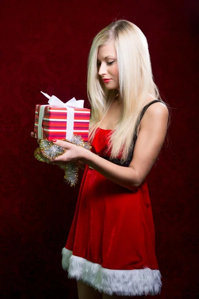 Portrait of casual young happy blonde hold striped gift box — Stock Photo, Image