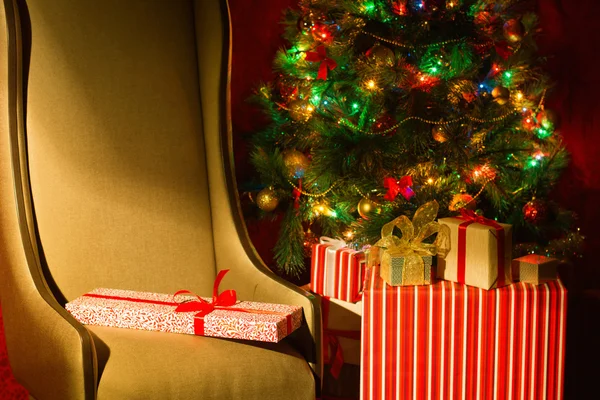 Christmas interior with illuminated Christmas tree and chair. — Stock Photo, Image