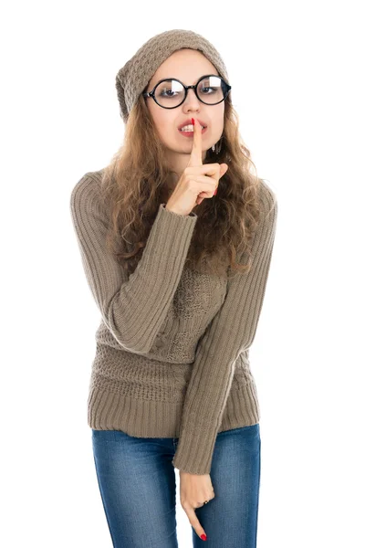 Retrato de una mujer joven con el dedo en los labios y pidiendo a —  Fotos de Stock