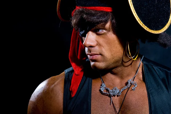 Close-up portrait muscular pirate in the studio on a dark backgr — Stock Photo, Image