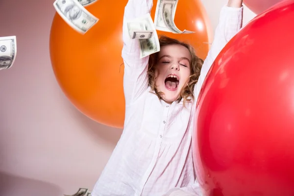 Happy teenage girl with an open mouth and falling on top of doll — Stock Photo, Image