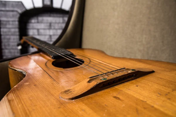 Primer plano de la guitarra acústica acostado en el sofá — Foto de Stock