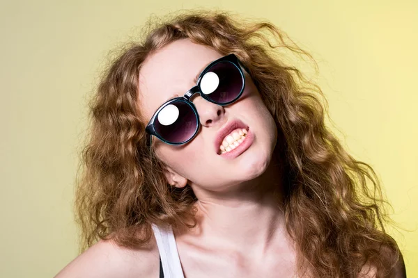 Pretty young capricious beautiful girl in sunglasses — Stock Photo, Image