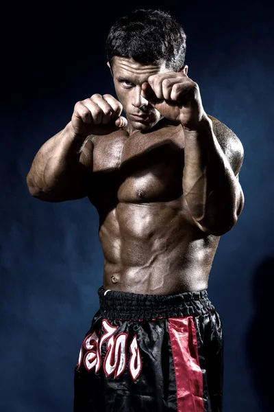 Fighter in a rack with fists. Portrait of a kick-boxer — Stock Photo, Image