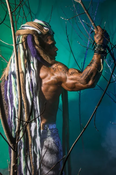 Uomo muscolare con dreadlocks nella foresta — Foto Stock