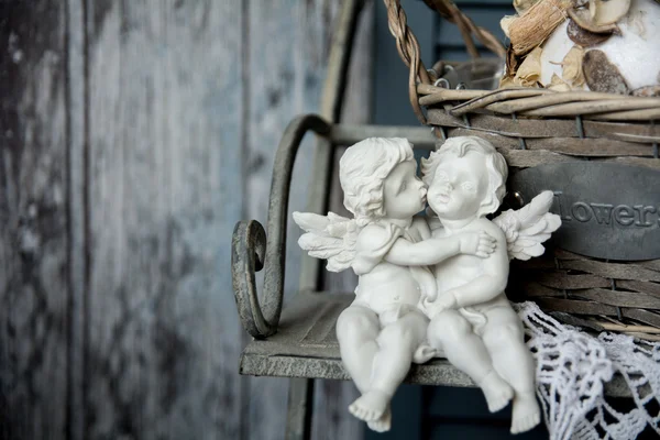 Figurines angels sitting on a bench — Stock Photo, Image