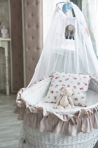 Retro dormitorio infantil interior con una cuna de mimbre y teddy b — Foto de Stock