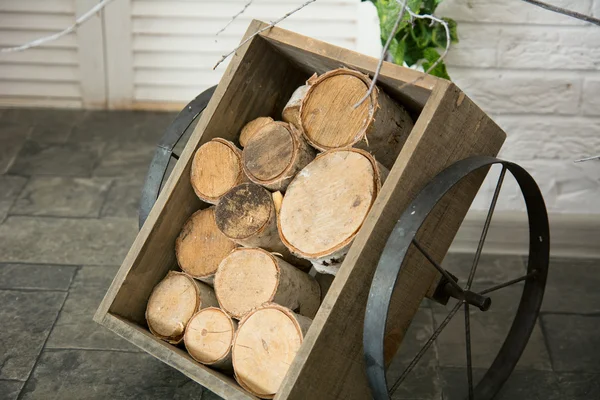Birch logs in a wooden cart with iron wheels — Stock Photo, Image