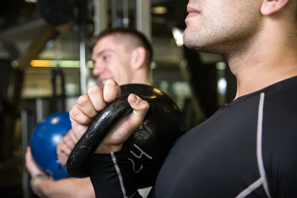Kettlebell swing training of two young men in the gym — Stock Photo, Image