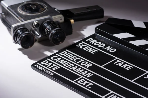 Old camera with two lenses and a movie clapperboard — Stock Photo, Image