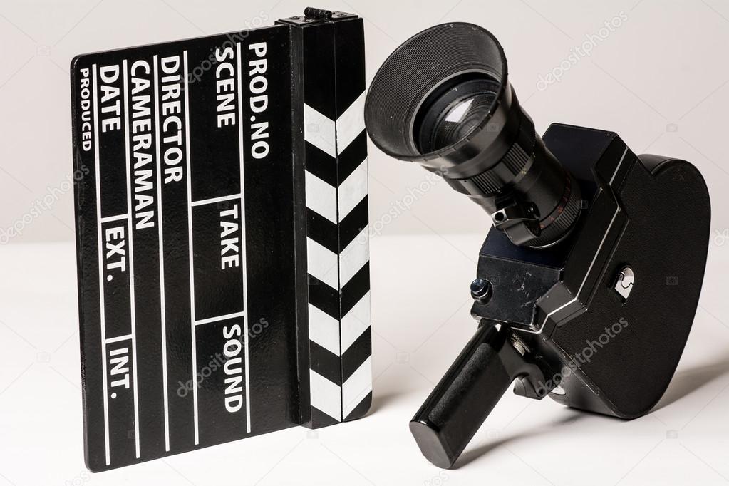 Old movie camera with film clapperboard. 
