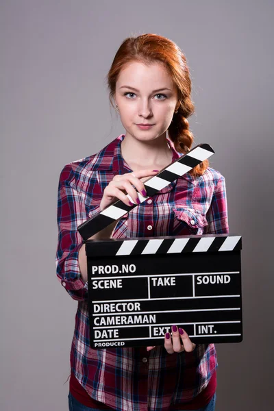 Mulher ruiva bonita segurando um filme palmas — Fotografia de Stock