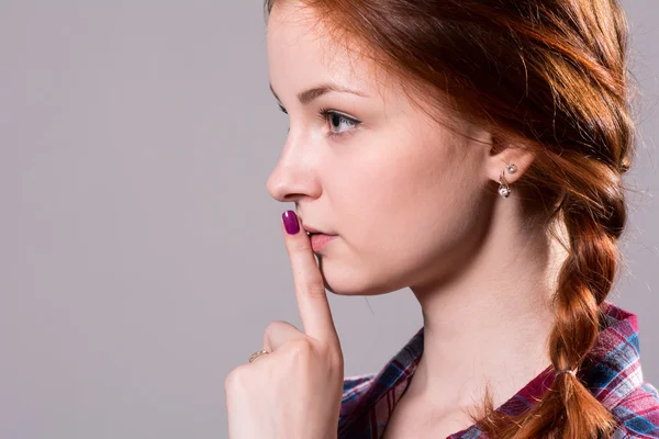 Psst - een mooi meisje met pigtails een shushing gebaar maken — Stockfoto