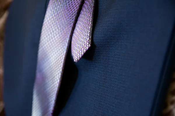 Closeup of a tie lying on blue trousers — Stock Photo, Image