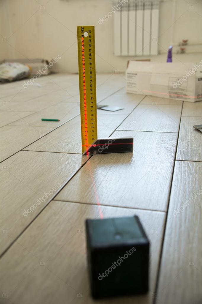 Laser Level With A Square On The Floor Tiles Stock Photo