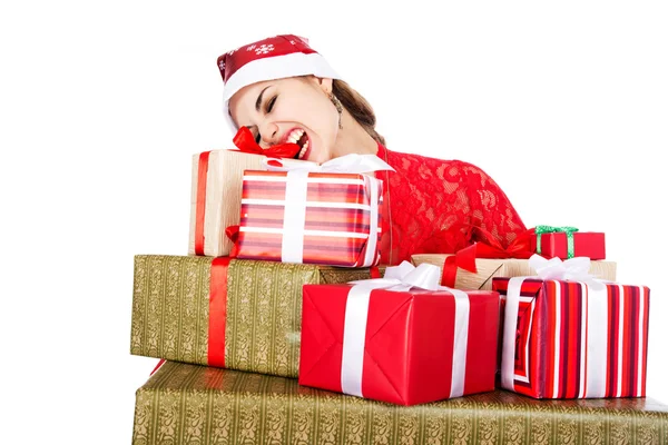 Young girl in Santa hats teeth trying to open a box with a gift — Stock Photo, Image