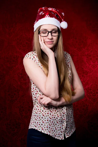 Girl in santa hat with closed eyes in glasses — Stock Photo, Image