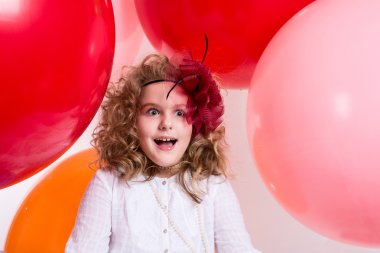 Surprised girl in a hat of the bow against the backdrop of a lar