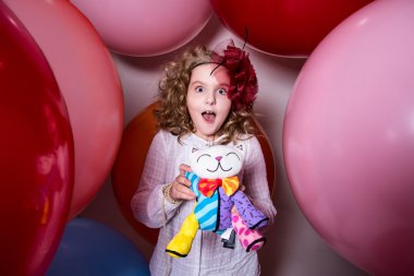 Surprised girl in a hat of the bow against the backdrop of a lar